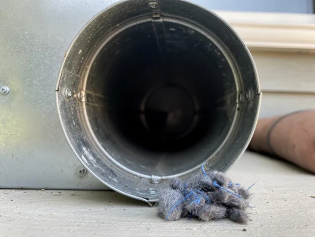 New Albany Dryer Vent Cleaning technician using specialized equipment to clear severe dryer vent blockage in New Albany